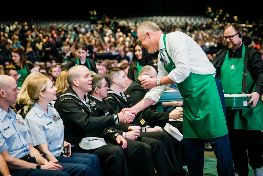 Starbucks terzo luogo Il ceo di Starbucks Kevin Johnson serve i caffè a dei militari americani durante l'assemblea degli azionisti che si è svolta il 20 marzo al WaMu Theatre di Seattle (credits: Lindsey Wasson)